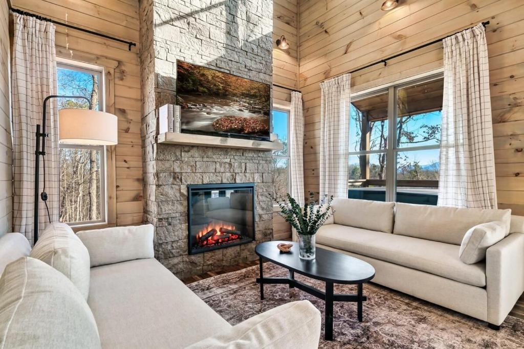 a living room with a couch and a fireplace at Charming Hideaway with Private Pool Hot Tub & Views in Gatlinburg