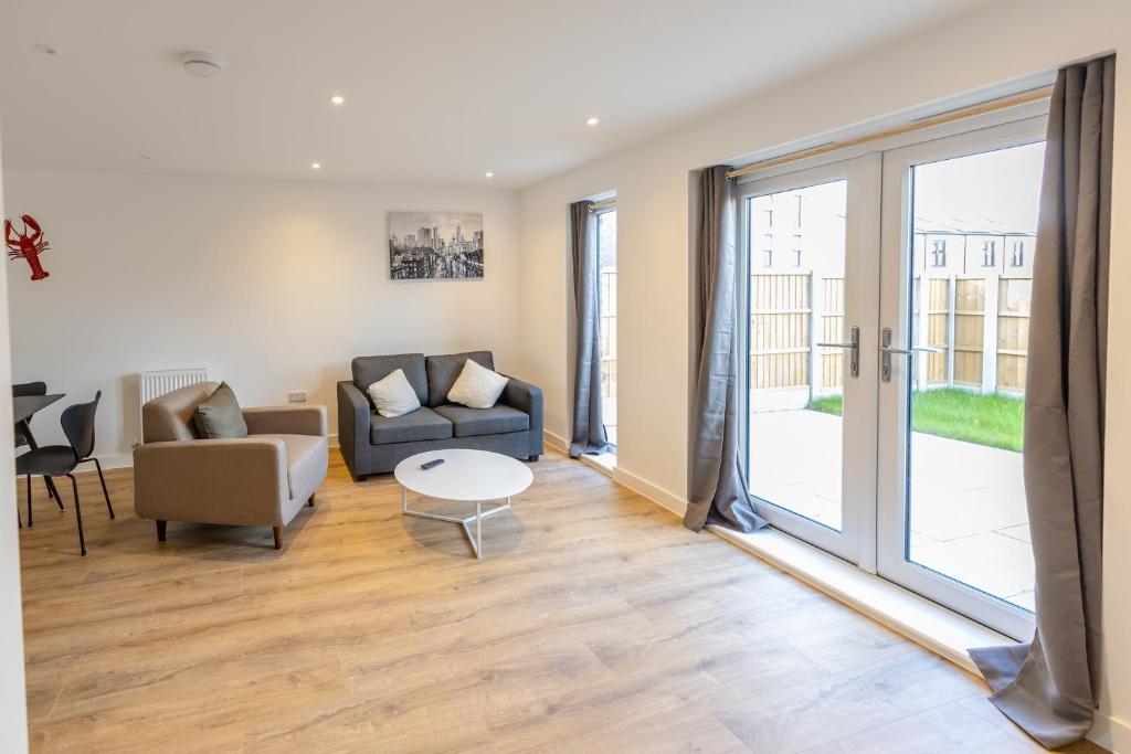 a living room with a couch and a table at Joyful Management - A Mordern Semi-Detached House with 3 bedroom in Manchester