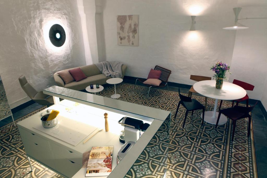 a living room with a couch and a table at Palazzina Alchimia in Fasano