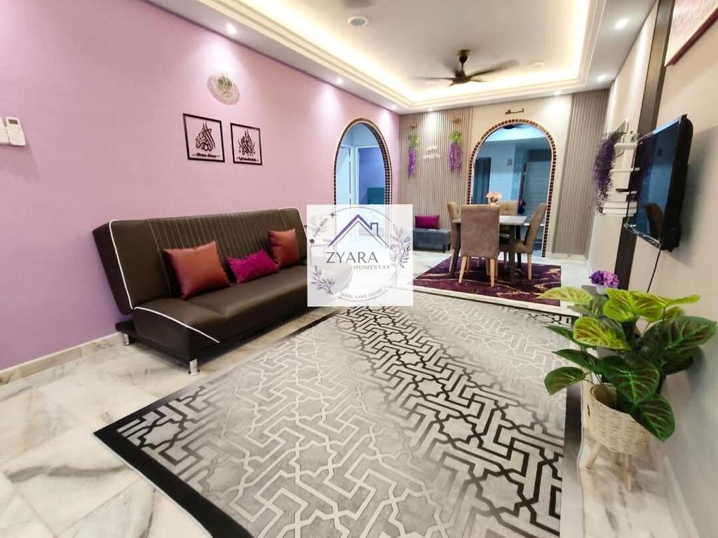 a living room with a couch and a table at Zyara Homestay Seremban in Seremban