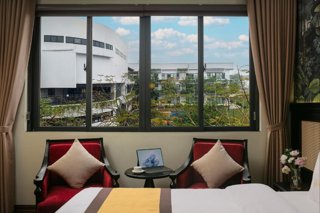 Postel nebo postele na pokoji v ubytování Grand Hanoi Hotel