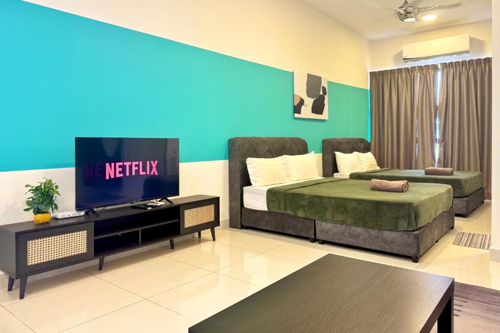 a bedroom with a bed and a tv in it at Core Soho Luxury Designer Suite KLIA in Sepang