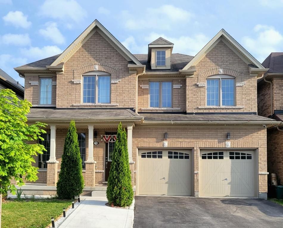 a brick house with two garages at Luxury Suite - Master Bedroom in Niagara Falls