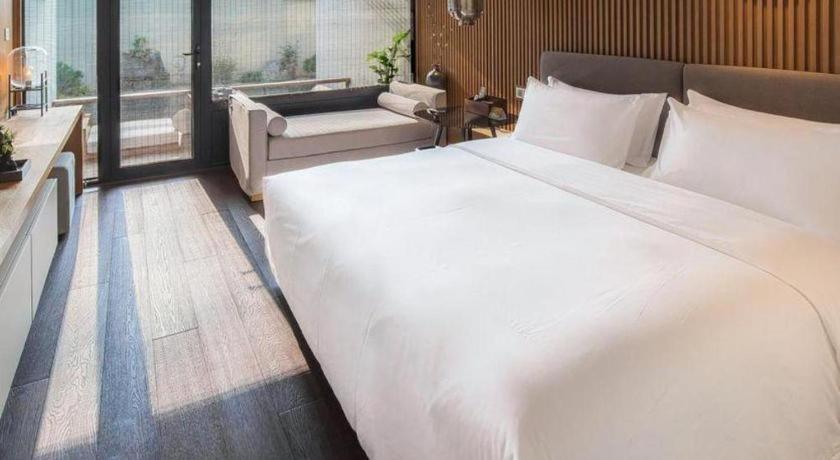 Postel nebo postele na pokoji v ubytování Tiantai Hotel