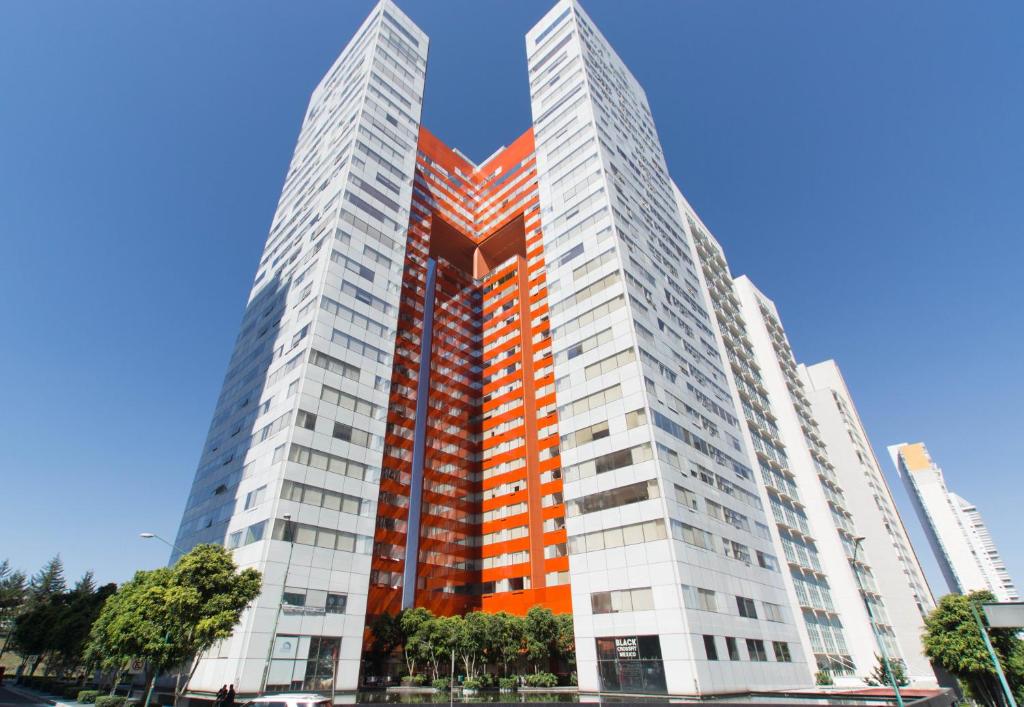 two tall buildings in a city at Hausuites in Mexico City