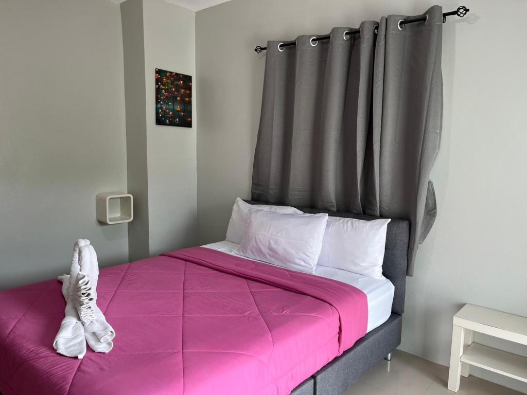 Postel nebo postele na pokoji v ubytování Papangkorn House