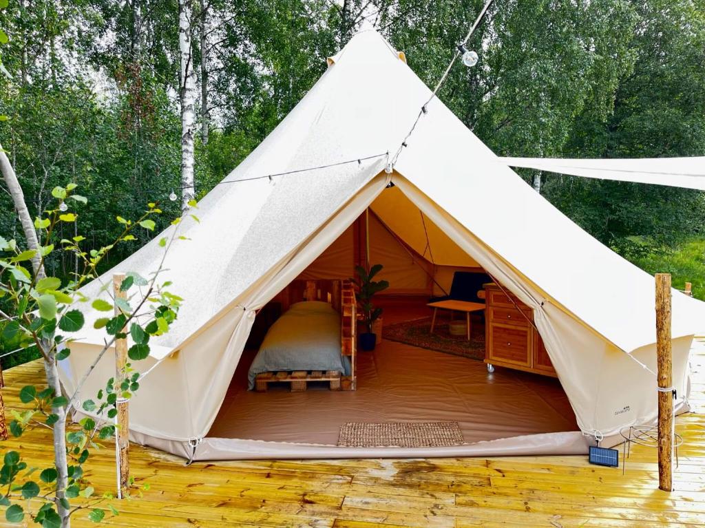 a white tent with a bed in it at Slow Life Sweden - Family Glamping Tent Poppel 
