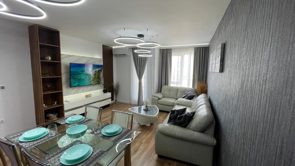 a living room with a couch and a glass table at Тони апартмент in Burgas City