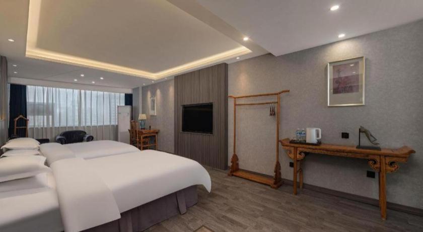 Postel nebo postele na pokoji v ubytování Xi'an Huiya Tianmu Hotel