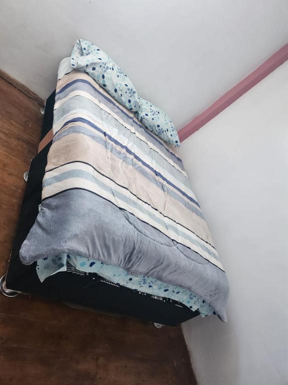 a pillow sitting on top of a bed at Departamento esmeralda in Chota