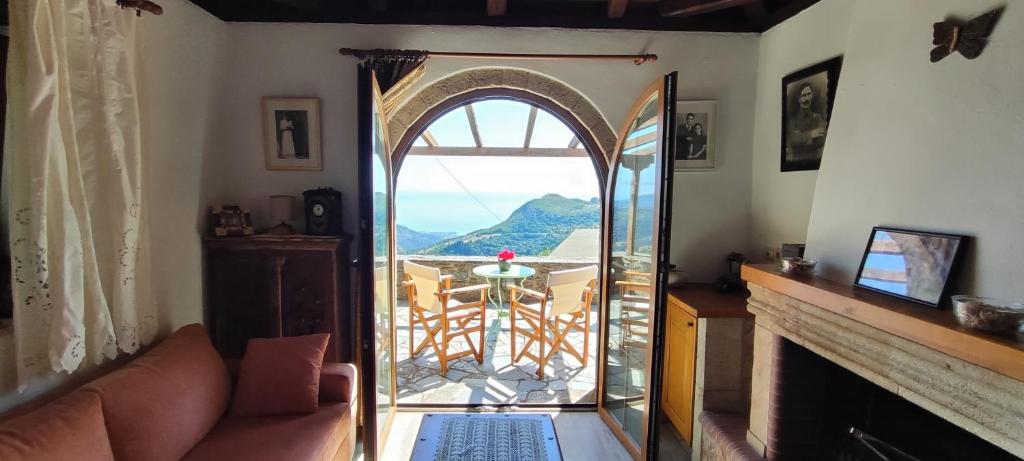 a living room with an open door to a balcony at koule Tasoula in Monemvasia