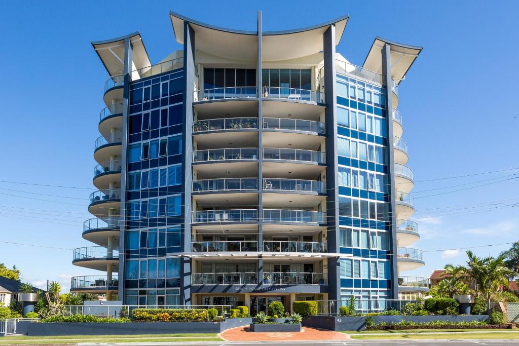 a tall building with blue windows at Beach House on Suttons in Redcliffe