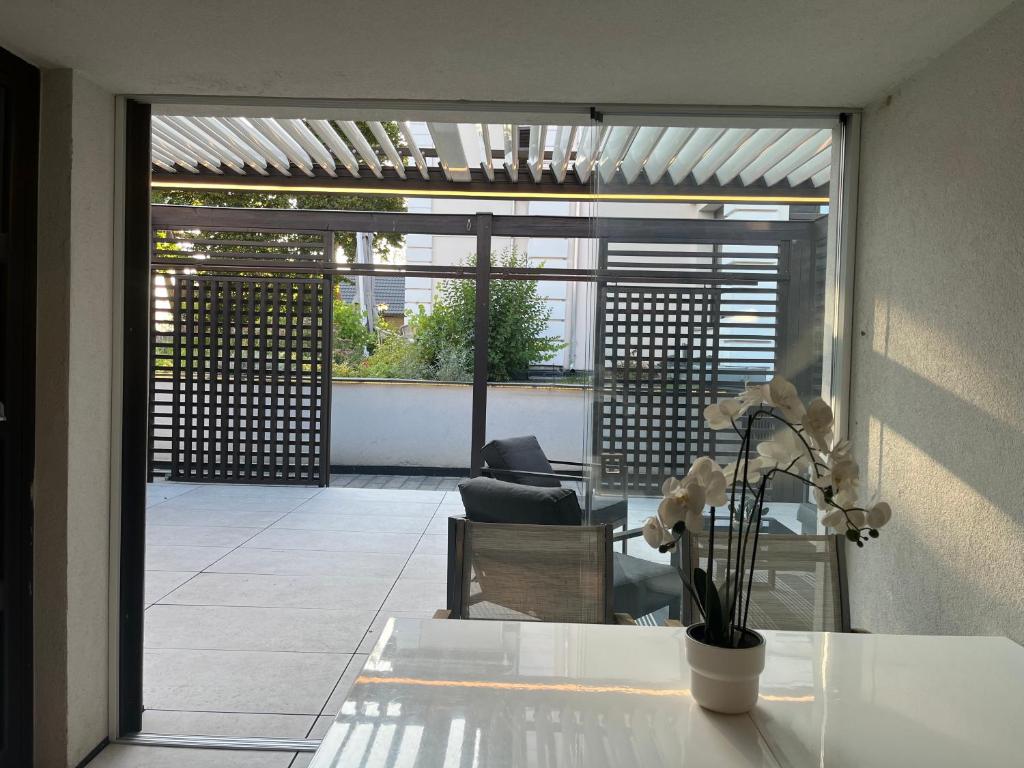 a room with a table with a vase of flowers on it at Jókai24 in Balatonfüred