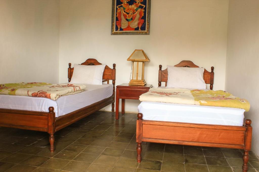 Postel nebo postele na pokoji v ubytování Bendesa Mas Homestay