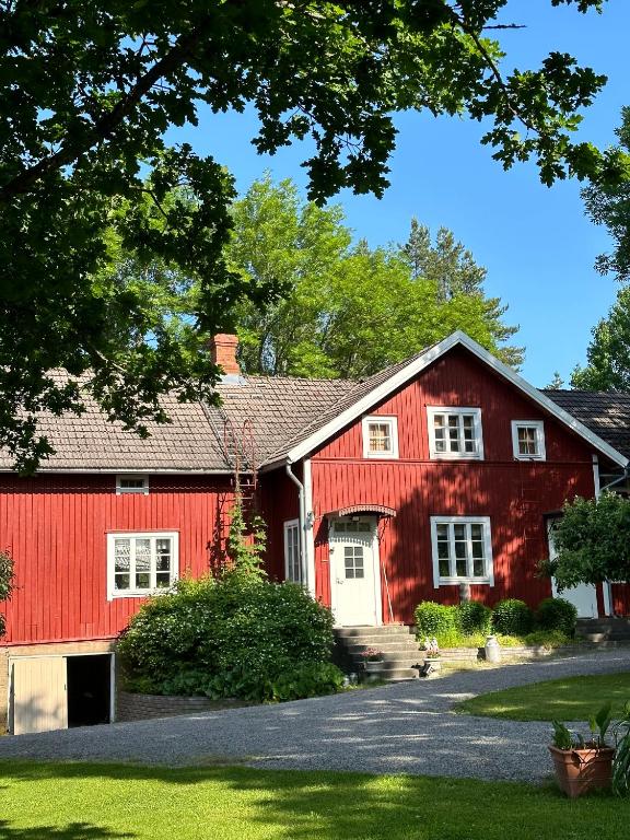 a red barn with a white garage at Lillby Bed and breakfast2 in Lehtinen