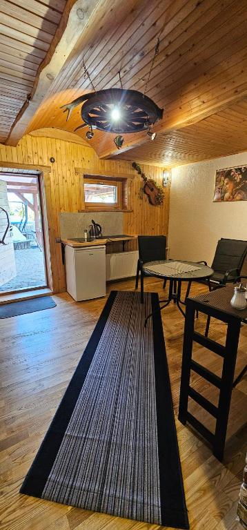 a living room with a table and a kitchen at Dīva in Pāvilosta