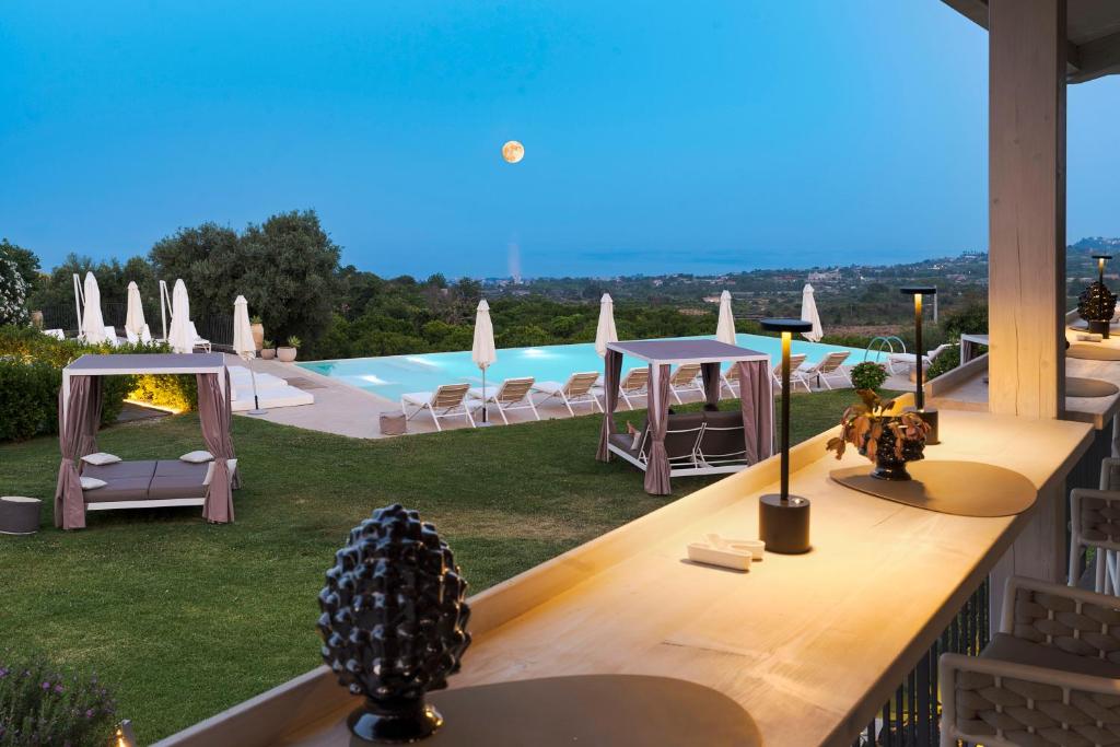 a view of a swimming pool from a house at Kepos Etna Relais & Exclusive Spa in Santa Venerina