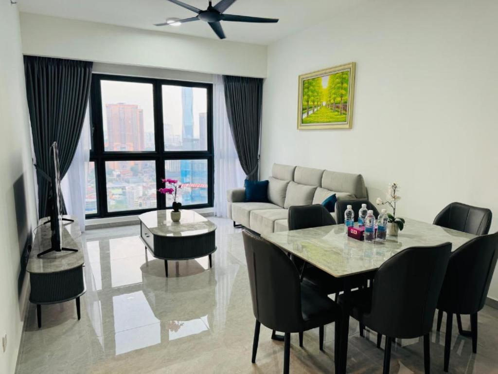 a living room with a table and a couch at Homestay Agile At Bukit Bintang KL in Kuala Lumpur