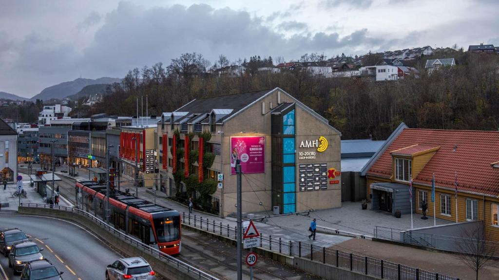a bus is parked in front of a train station at Newly Renovated Rom Bergen Fana in Bergen