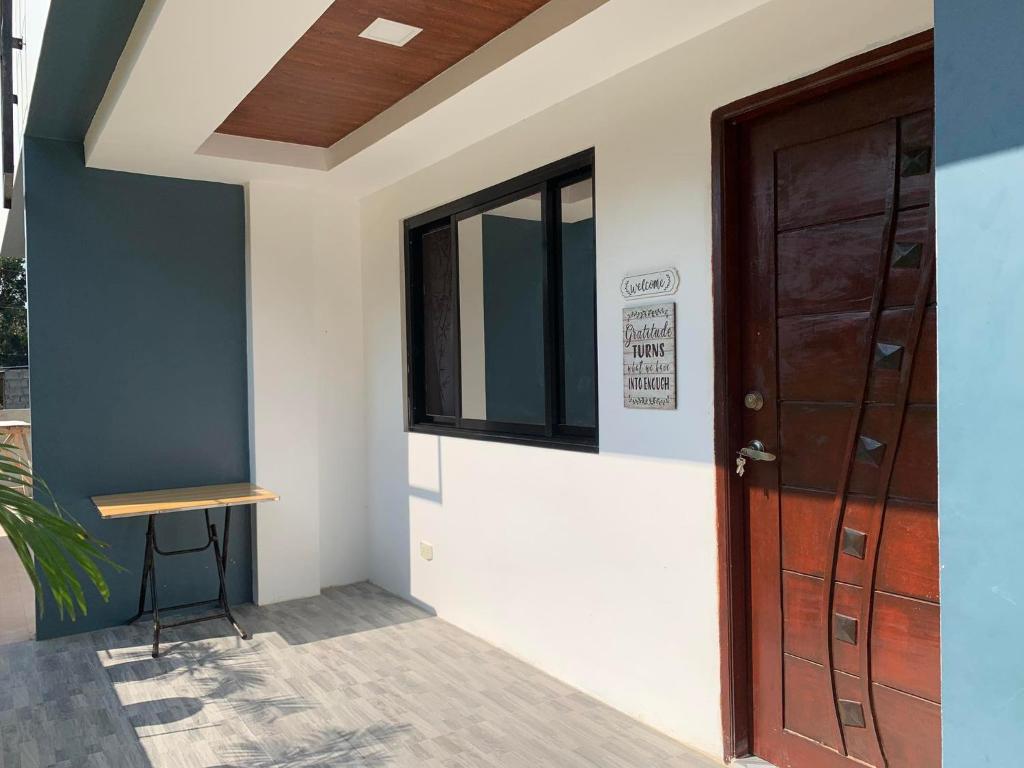 a room with a door and a stool next to it at 3Vhin Transient House in Sampong