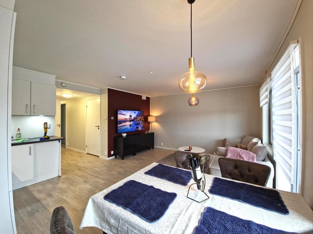 a kitchen and living room with a table and a living room at Modern brand new apartment Kongsberg in Kongsberg