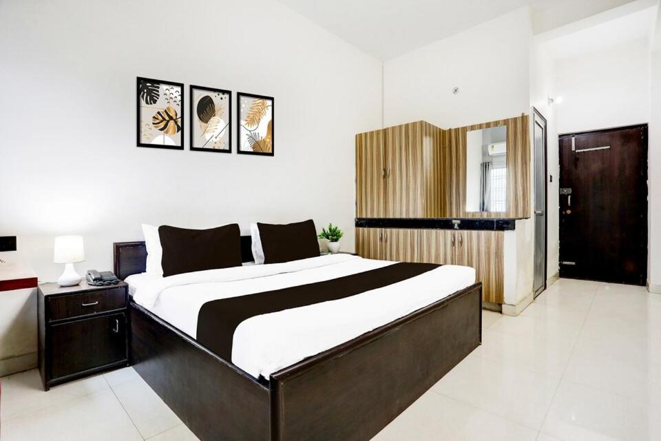 a bedroom with a large bed in a room at Hotel Shivam Grand Inn in Gorakhpur
