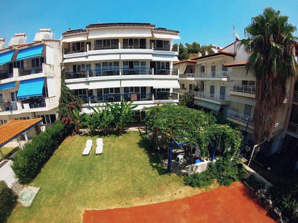 an aerial view of a large building with a yard at LAINAS apartments in Nea Skioni