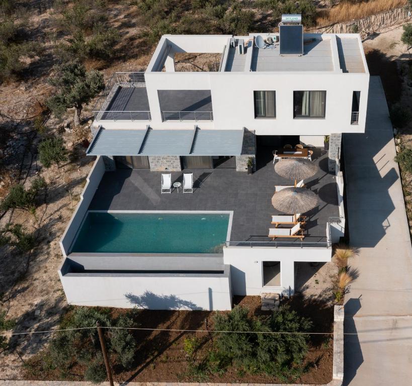 an aerial view of a white house with a swimming pool at Vista Komos Villa 2, New Villa with Private Pool in Pitsidia
