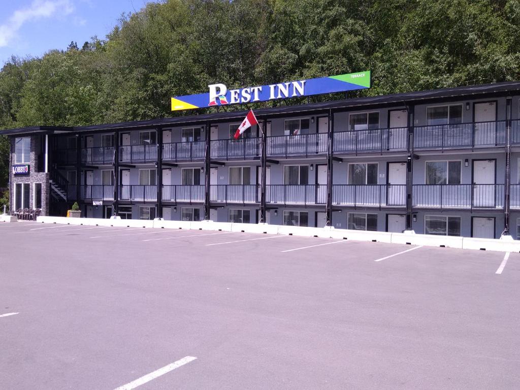 an empty parking lot in front of a hotel at Rest Inn in Terrace