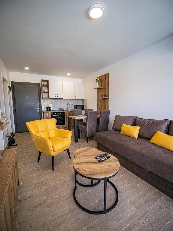 a living room with a couch and a table at Apartman Lakers in Ostrovo
