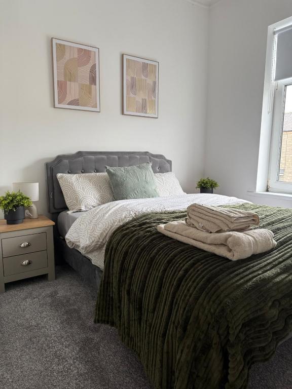 a bedroom with a bed with two towels on it at ResiLets - Stanley House - Large, Modern 3 Bed - NEW! in Blythe