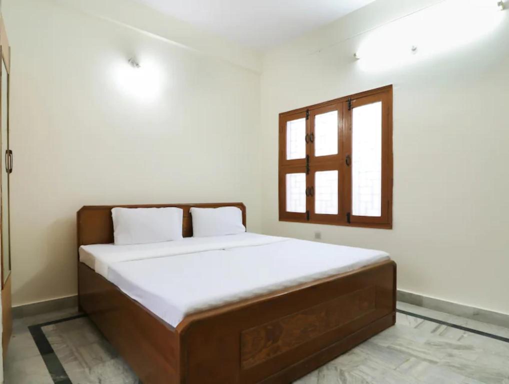 a bedroom with a large bed with a window at HOTEL SHREE BHAMESHWAR Near Mansa Devi Temple and Chandi Devi Temple# Ganga River - Fully Air conditioned Rooms - Best Budget Hotel in Haridwār