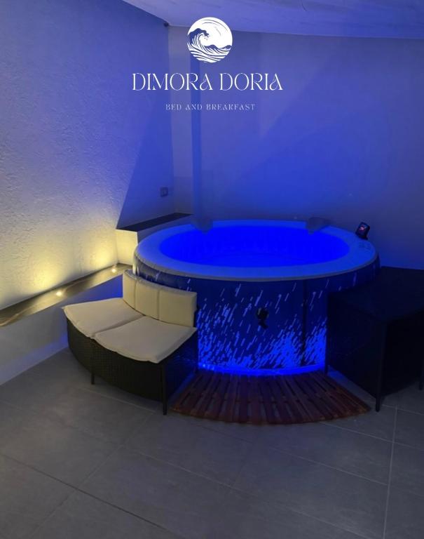 a blue tub with a bench in a room at Dimora Doria in Bari