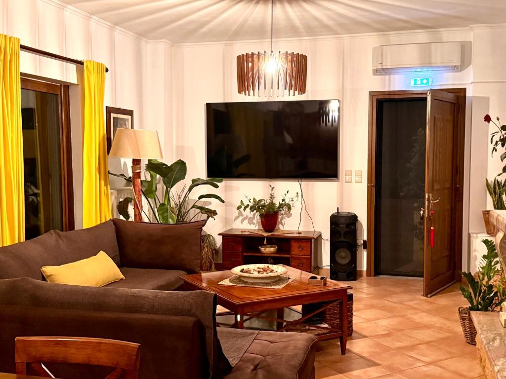 a living room with a couch and a table at Jasmine place in Kalamata