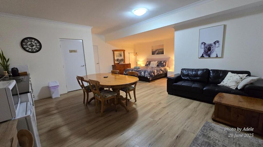 a living room with a table and a couch at Pelican Rise with a little surprise in Narngulu