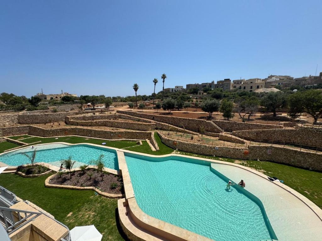 an overhead view of a pool in a resort at Wardija Heights Luxury Penthouse in Qala