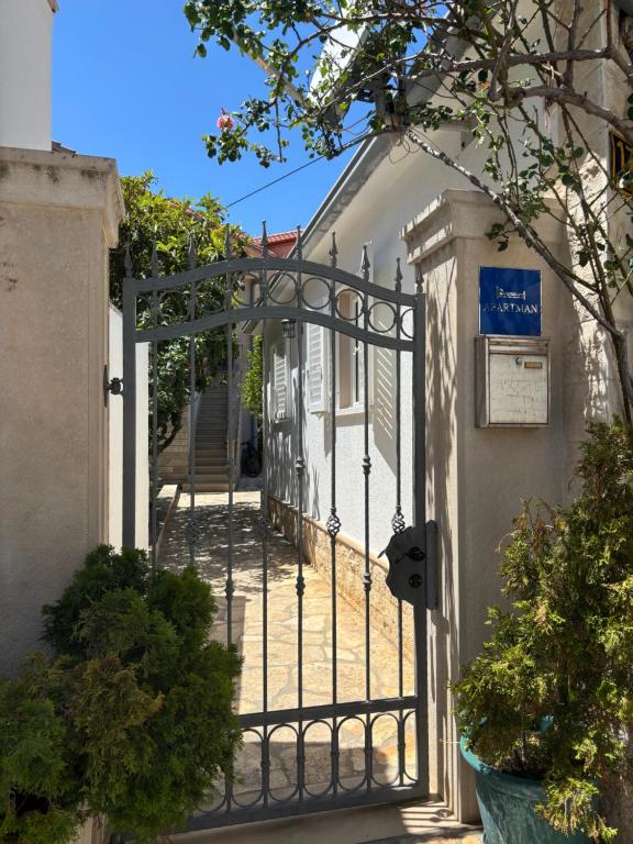 an entrance to a house with an iron gate at Apartment Ivic in Bol
