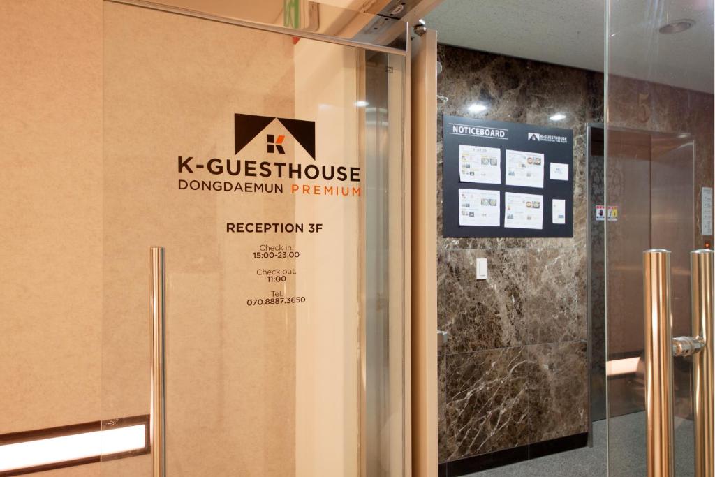 a door in a building with a sign on it at K-Guesthouse Dongdaemun Premium in Seoul