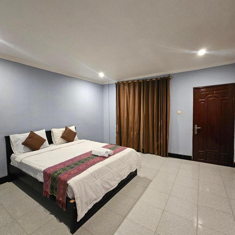 Postel nebo postele na pokoji v ubytování Ridho Malik Hotel
