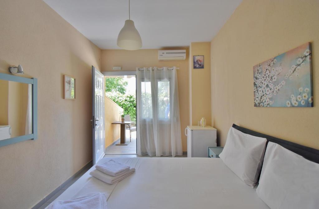 Postel nebo postele na pokoji v ubytování Hotel Argilos