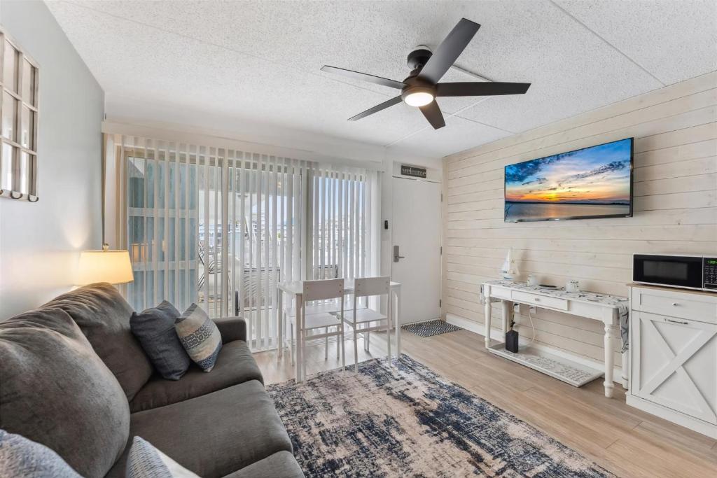 a living room with a couch and a ceiling fan at 301 Ocean Ave, Unit 206 - The Harbor Light in North Wildwood