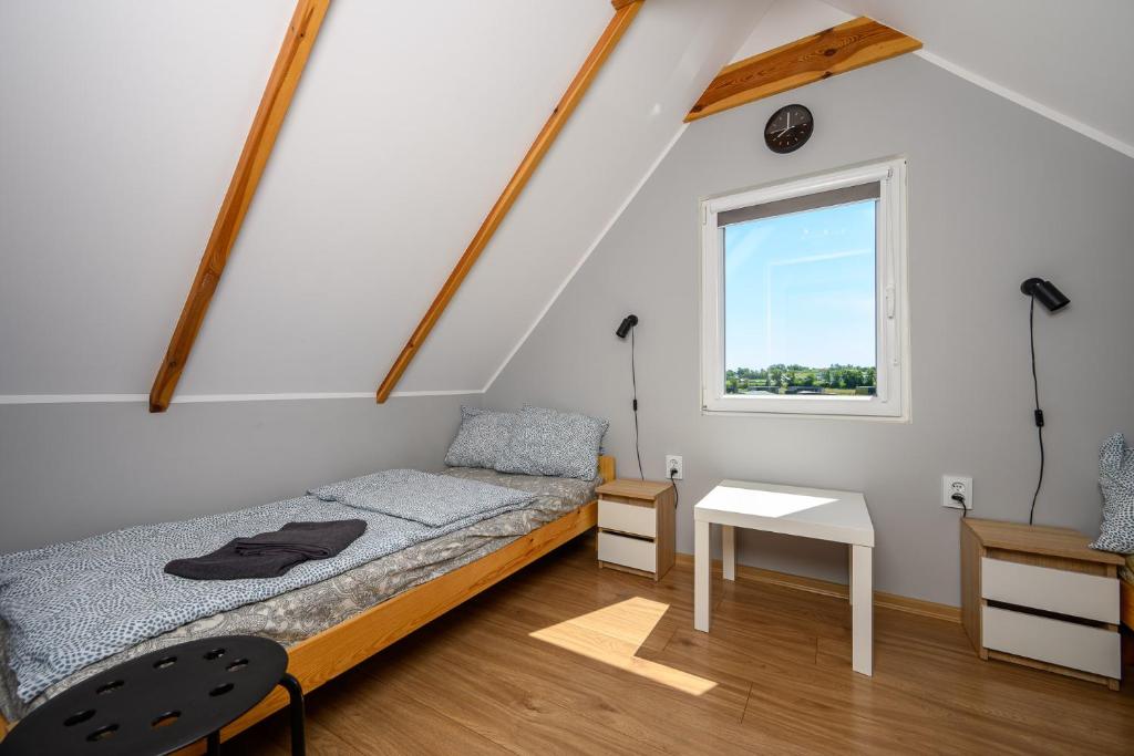 a small bedroom with a bed and a window at Kolorowy Kopań balia z hydromasażem w tarasie NA WYŁĄCZNOŚĆ in Kopań