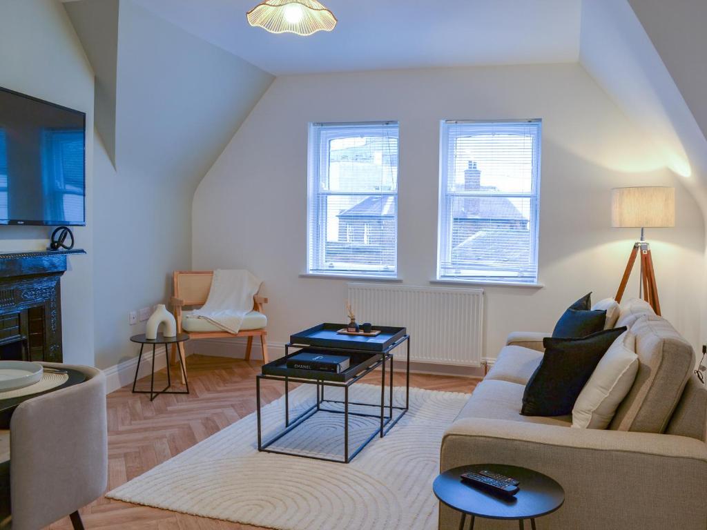 a living room with a couch and a table at Roof Tops in York