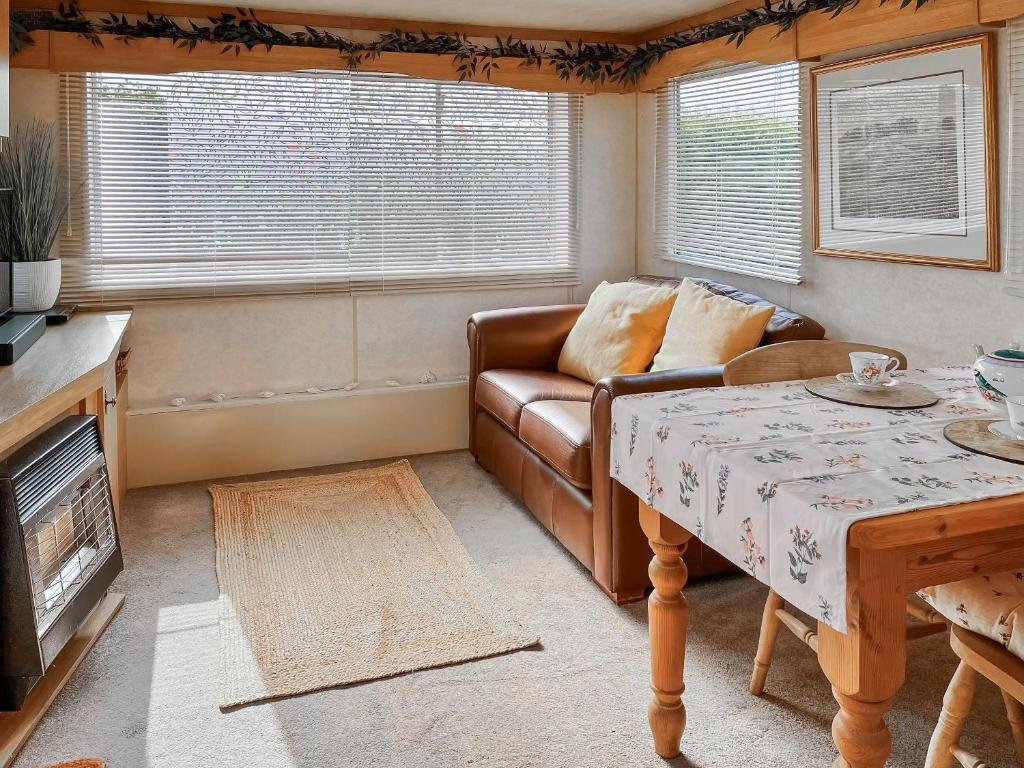 a living room with a couch and a table at Goldfinch - Uk48551 in Colchester