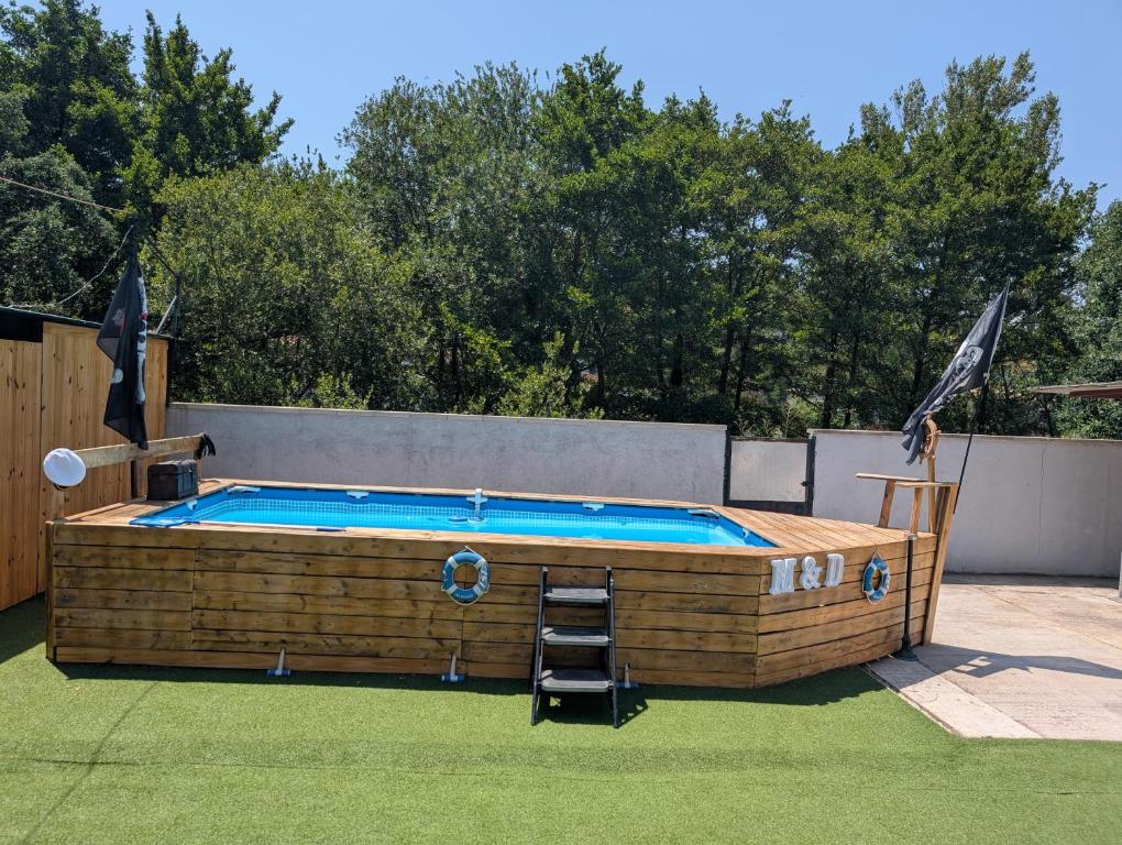 a swimming pool with a ladder in a yard at Casa M&D in Lloret de Mar