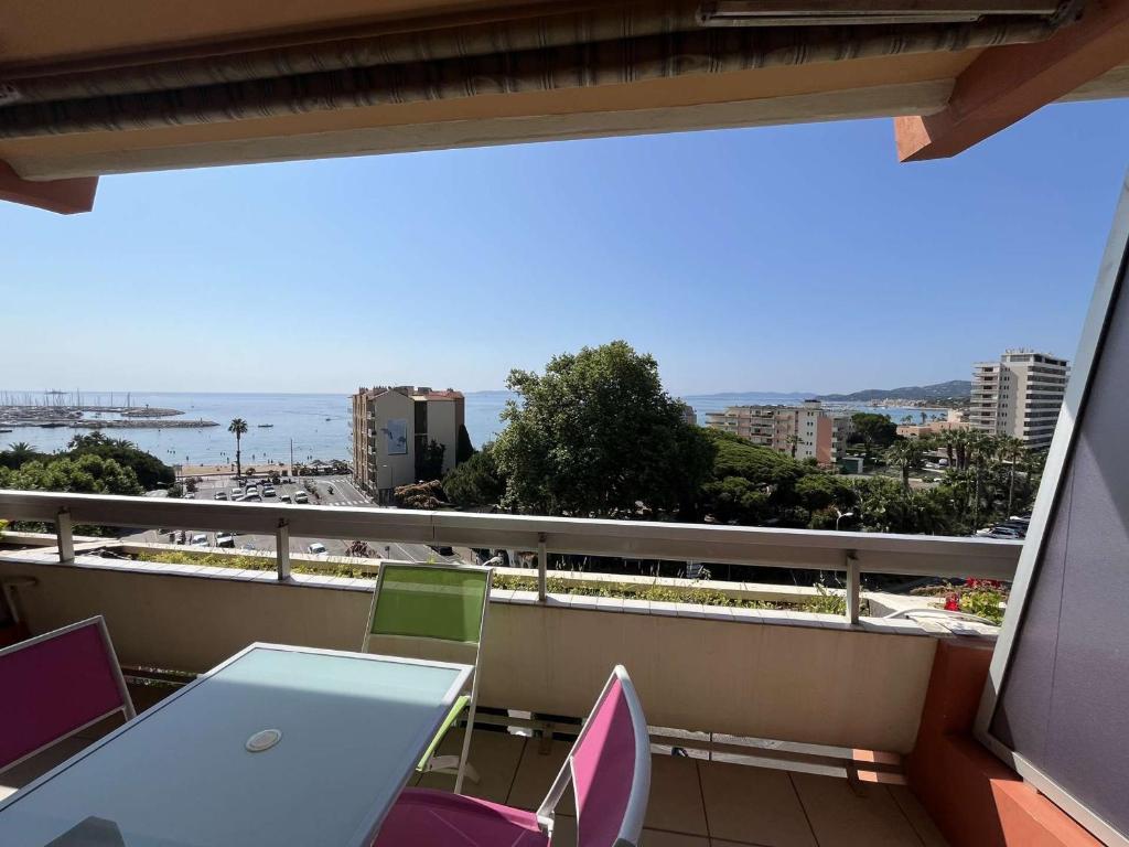 un balcon avec une table et des chaises et l'océan dans l'établissement Studio cosy au Lavandou avec terrasse et parking - FR-1-308-73, au Lavandou