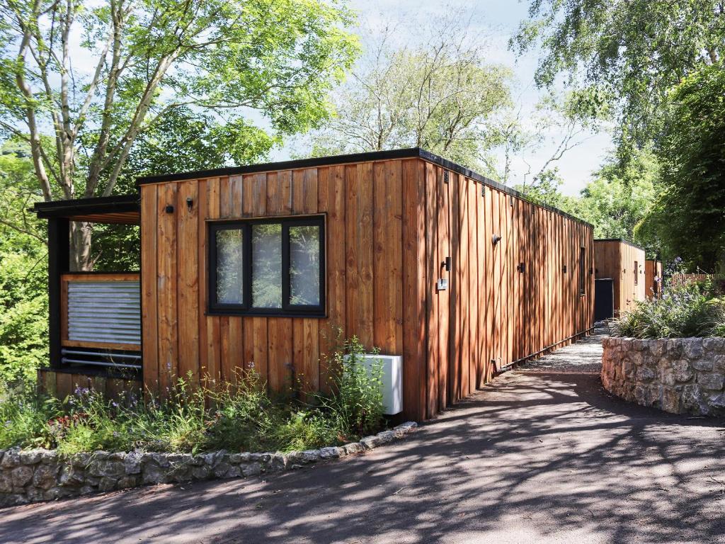 a wooden tiny house with a fence at Gwynant Lodge - Uk47608 in Caernarfon