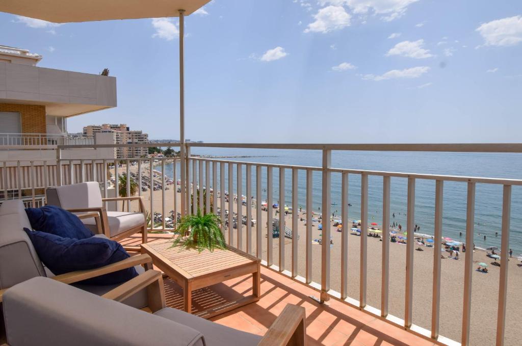 a balcony with chairs and a view of the beach at Ref 200 in Las Lagunas Mijas