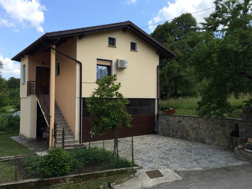 a house with a staircase in front of it at Apartment Konavec in Kobarid