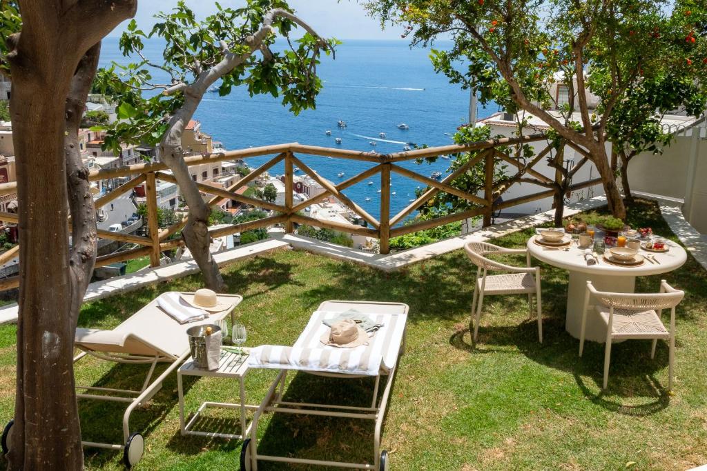 a patio with a table and chairs and the ocean at Casanova Suite in Positano